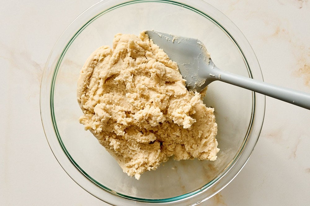 shortbread dough in a glass bowl for strawberry cobbler bars
