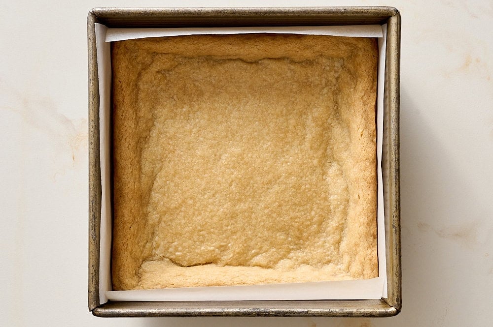 shortbread dough after cooling in pan to show slight dip in center for filling