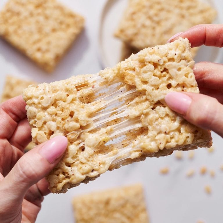 close-up of Tessa pulling apart gooey brown butter rice crispy treats