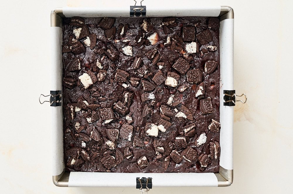 overhead view of Oreo brownie batter in metal pan before baking