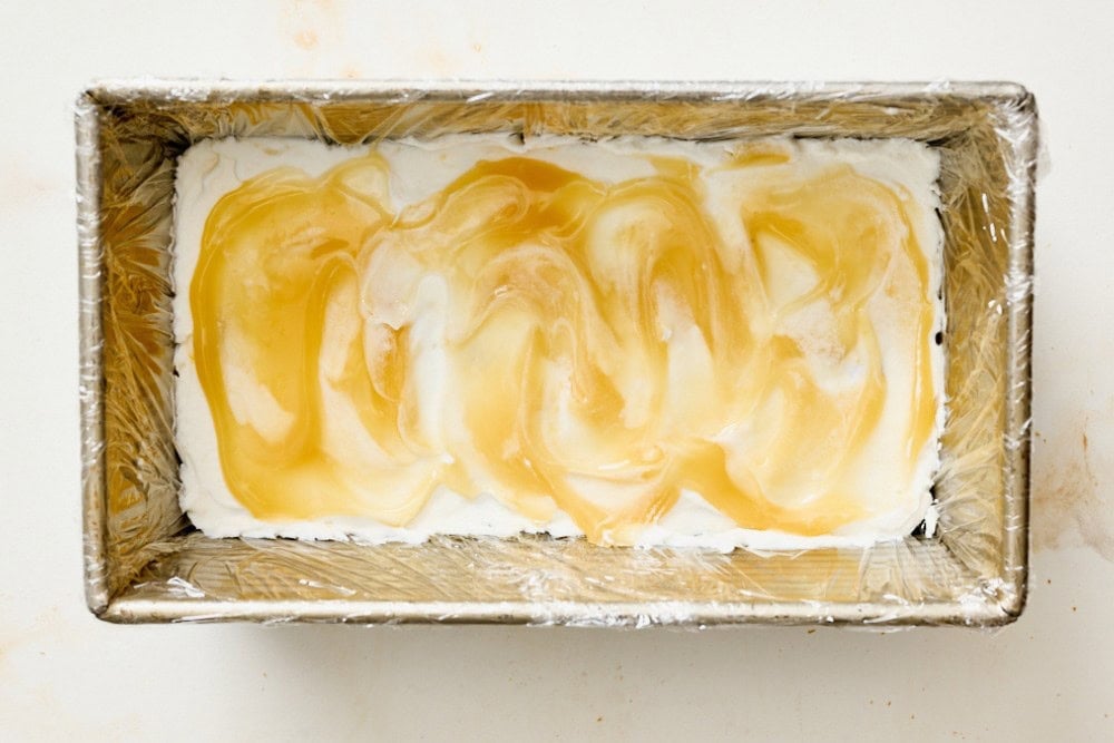 Lemon curd spread over the whipped cream layer in the icebox cake