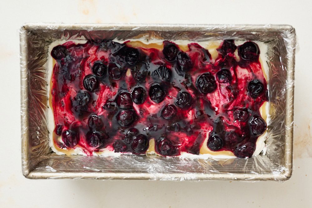 Blueberry sauce spooned over the lemon curd layer in the icebox cake