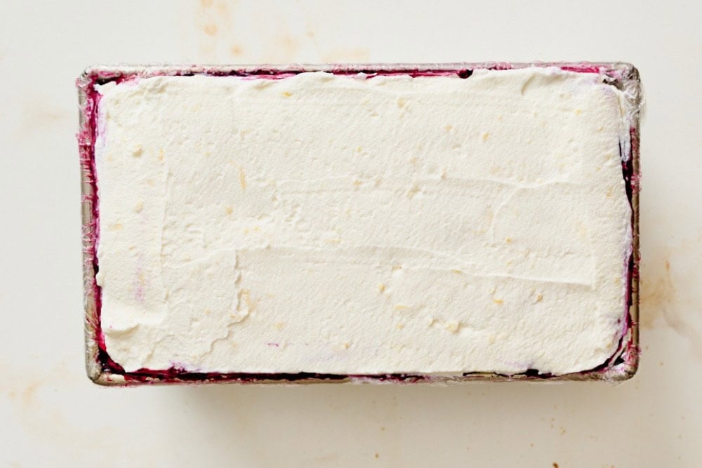 Fully assembled blueberry lemon icebox cake with layers of graham crackers, whipped cream, lemon curd, and blueberry sauce