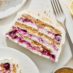 overhead view of a slice of blueberry lemon icebox cake on a plate with a fork