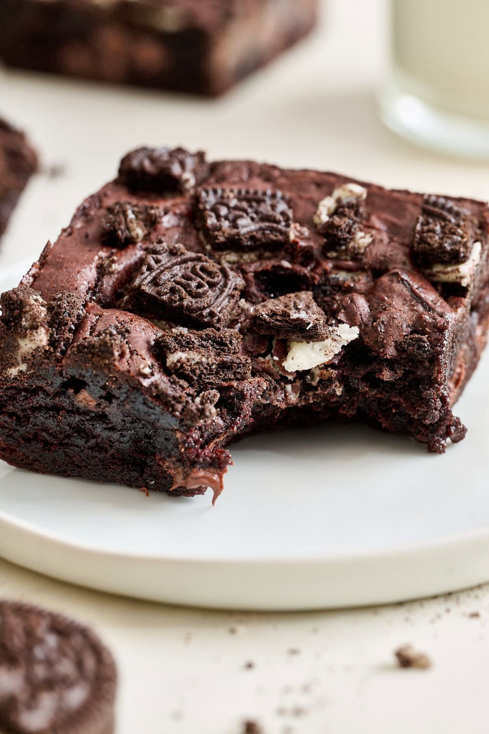 A chewy fudgy Oreo brownie on a small plate with a bite taken out