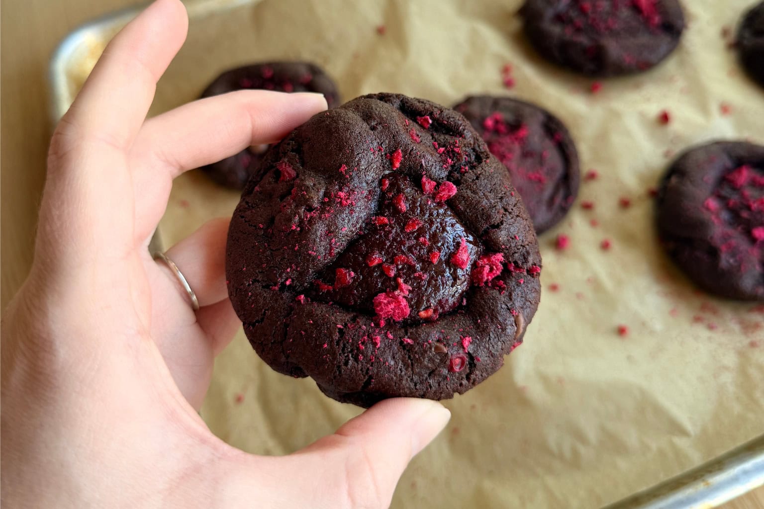 iphone photo of hand holding first batch of raspberry chocolate cookies