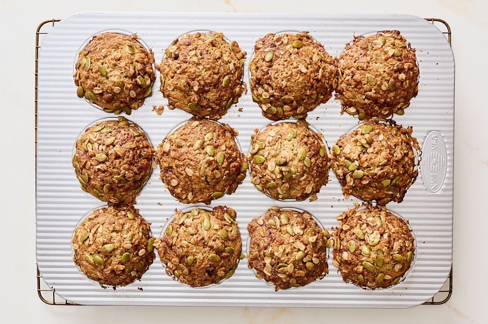 overhead view of freshly baked zucchini apple muffins in muffin tin