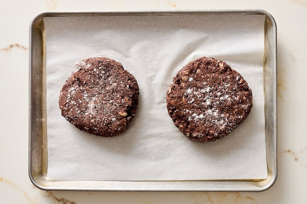 overhead view of two discs of mocha scone dough on a parchment lined baking sheet