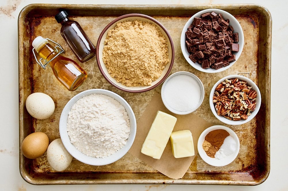 overhead view of all bourbon pecan chocolate chunk blondie ingredients on a tray