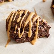 up close view of one mocha scone with espresso glaze on a parchment lined baking tray