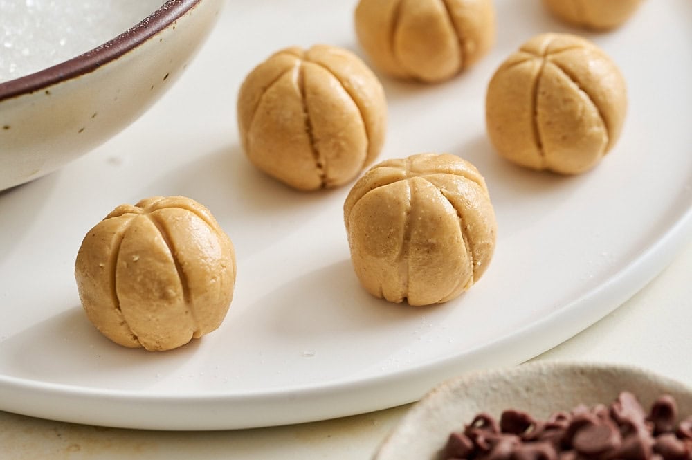 three quarters angle of peanut butter pumpkins before applying the mini chocolate chip "stem"