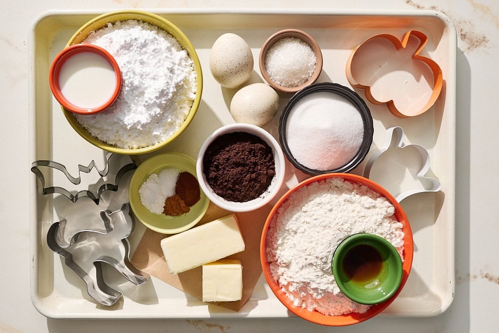 overhead view of all black cocoa halloween sugar cookie ingredients portioned and ready for assembly
