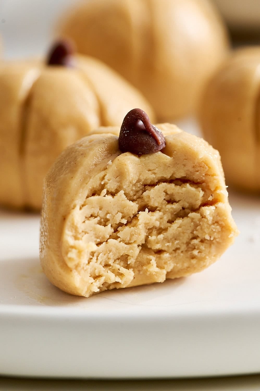 macro shot of a peanut butter pumpkin with a bite take out to show the soft yet sturdy center