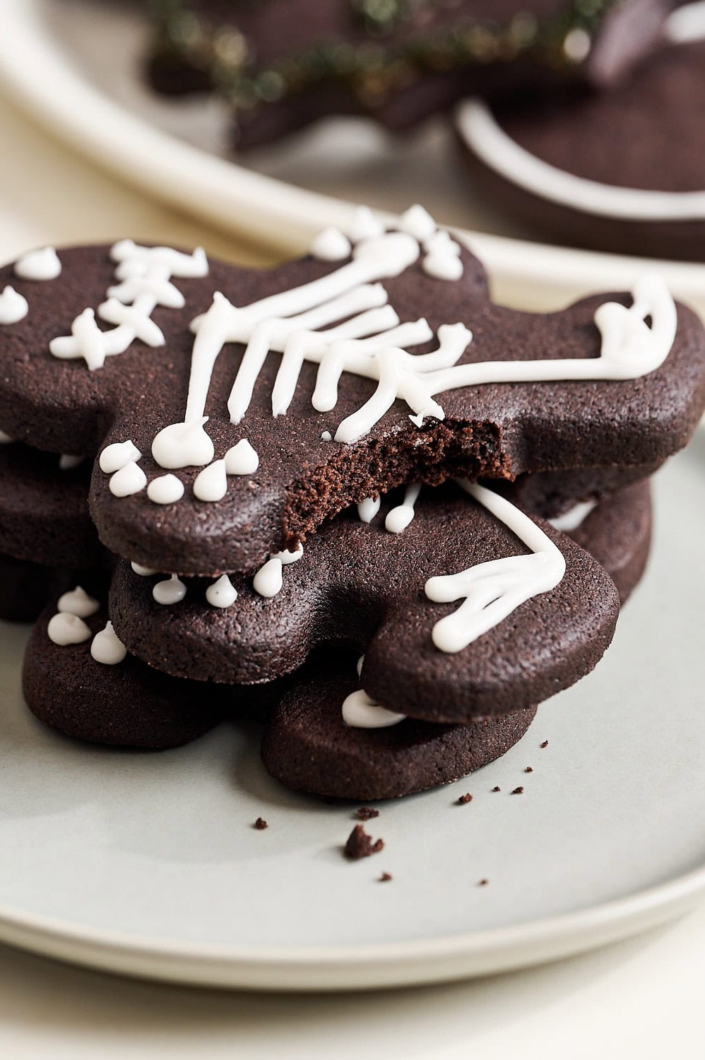 up close view of a bite taken out of a black cocoa Halloween sugar cookie to show soft interior