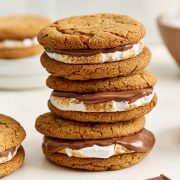 stack of three gingersnap s'mores, showing layers of soft cookie, gooey toasted marshmallow, and melty chocolate