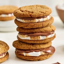 stack of three gingersnap s'mores, showing layers of soft cookie, gooey toasted marshmallow, and melty chocolate