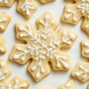 overhead view of decorated snowflake sugar cookies on a light colored surface